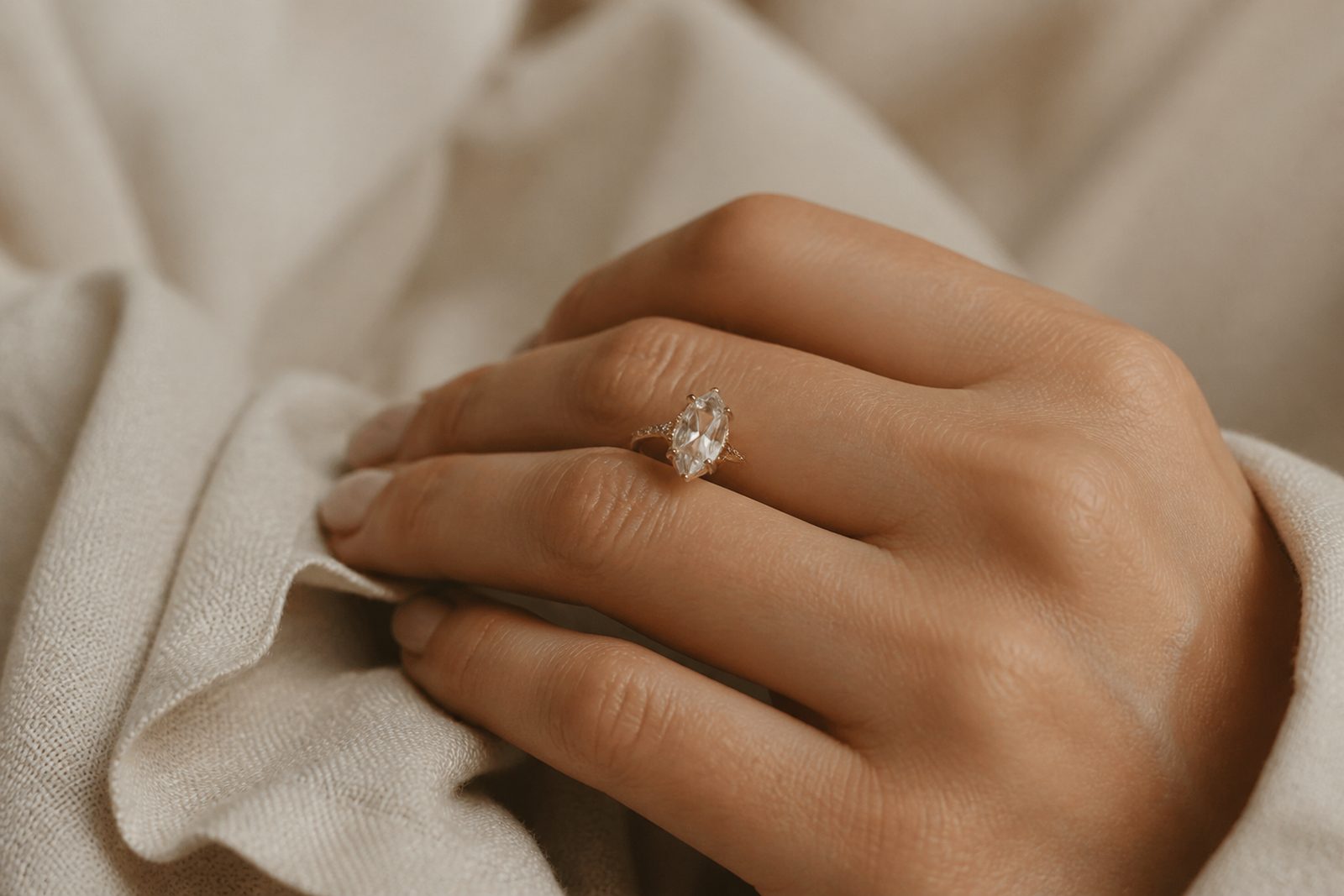 A custom gold ring worn on a hand
